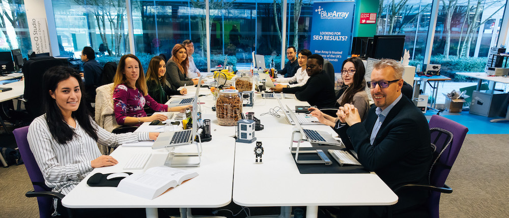 Team photo of Blue Array Blue Array's team sitting at their desks